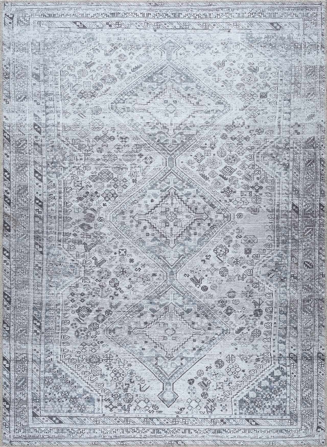 Patterned rug with geometric design in gray and white