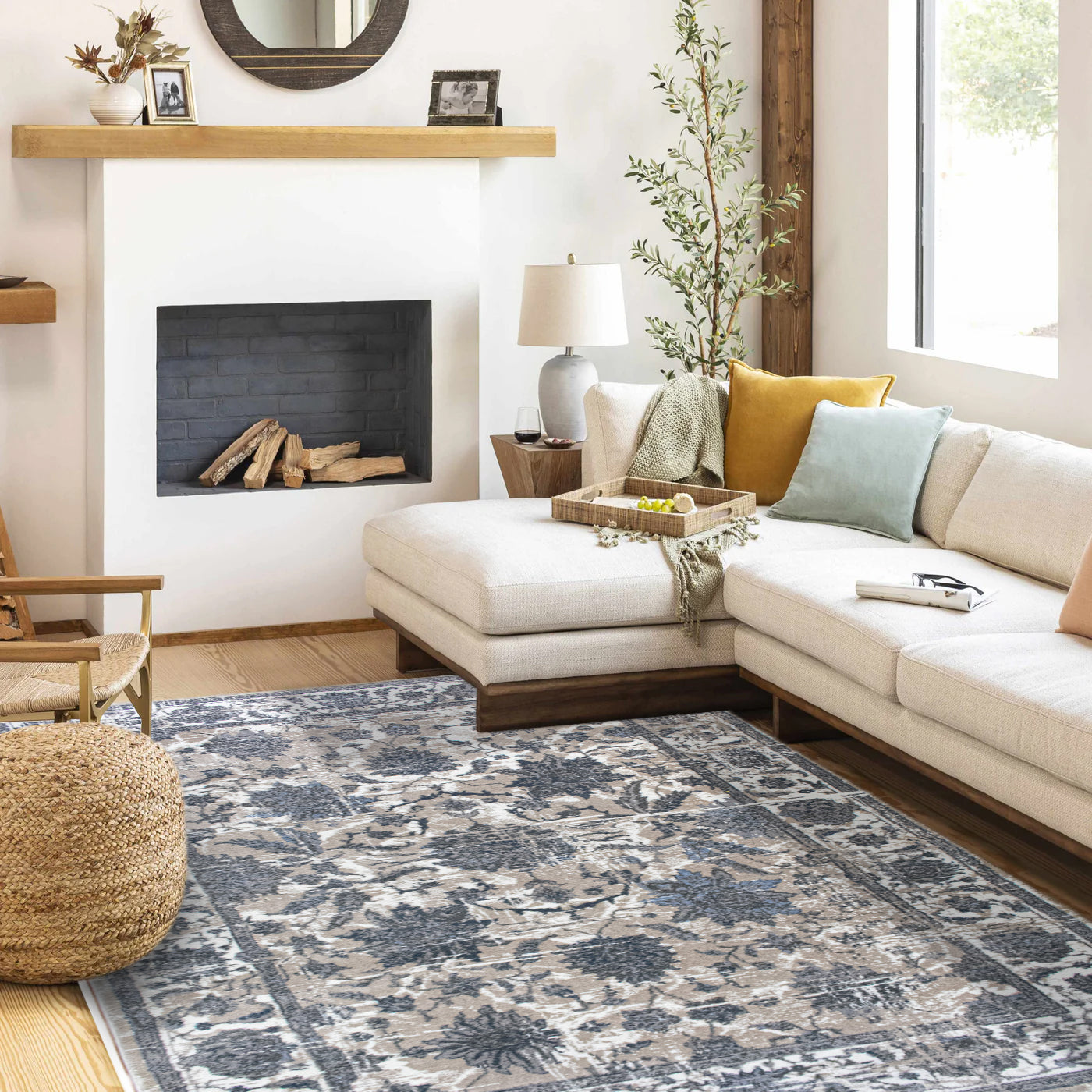 Living room with a sectional sofa, rug, and decorative items.