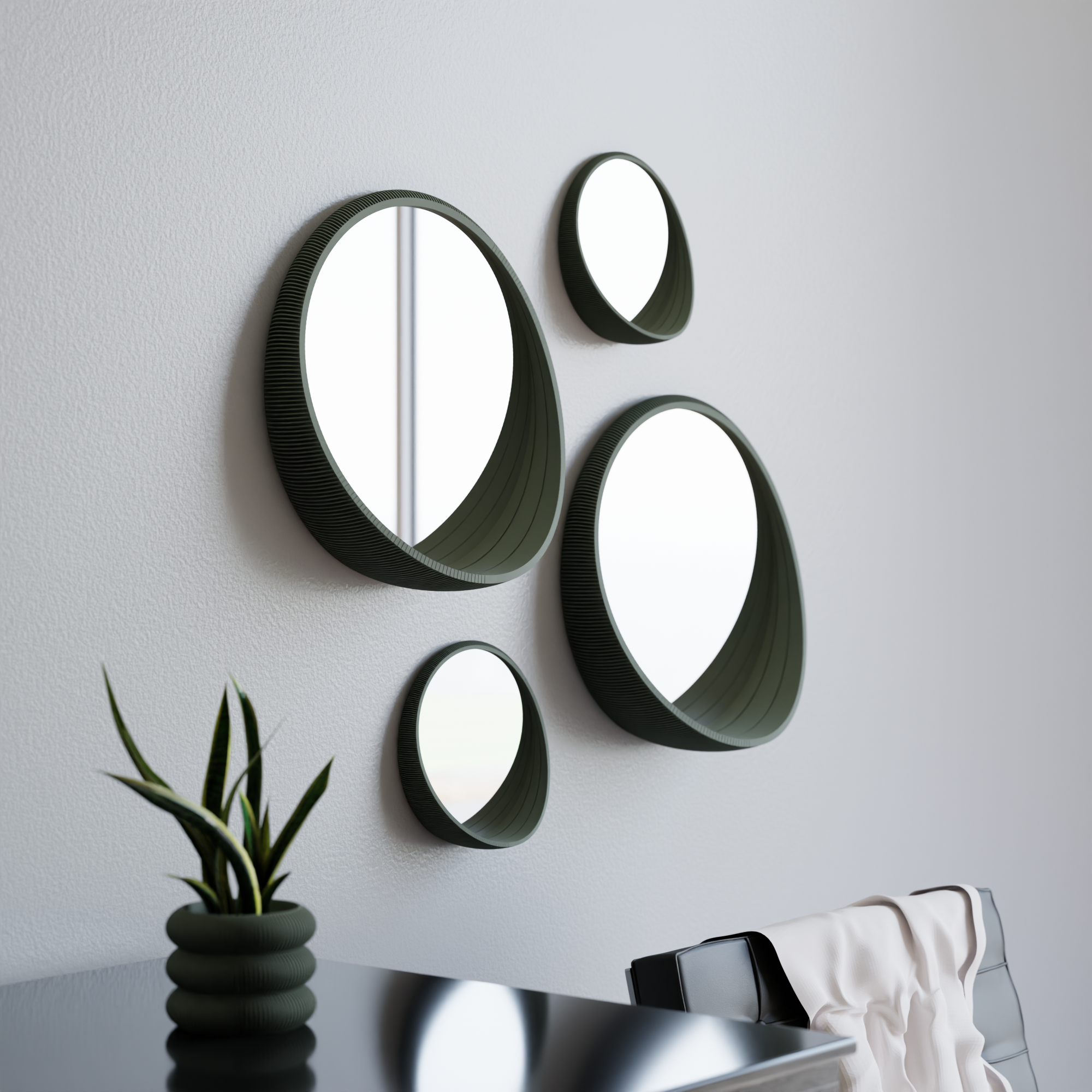 Set of round mirrors with green frames on a white wall.