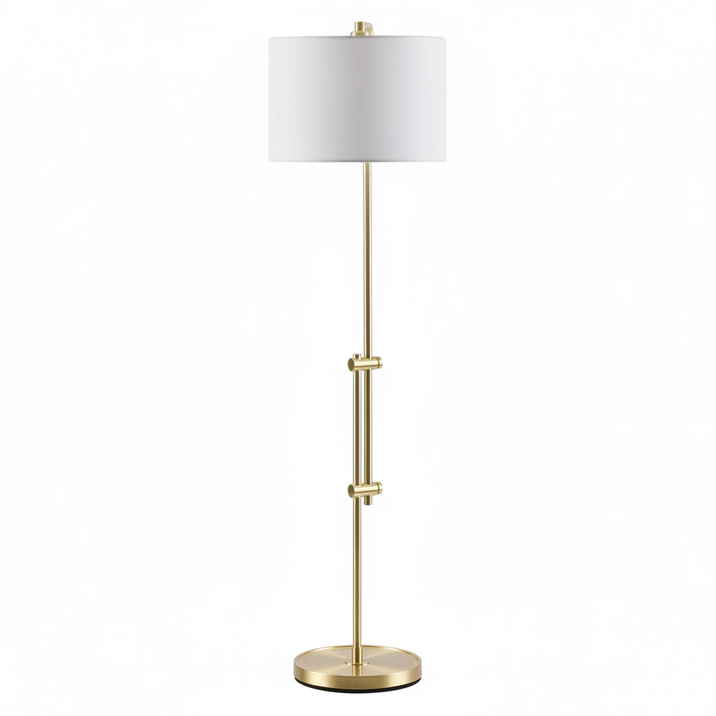 Gold floor lamp with a white shade on a white background