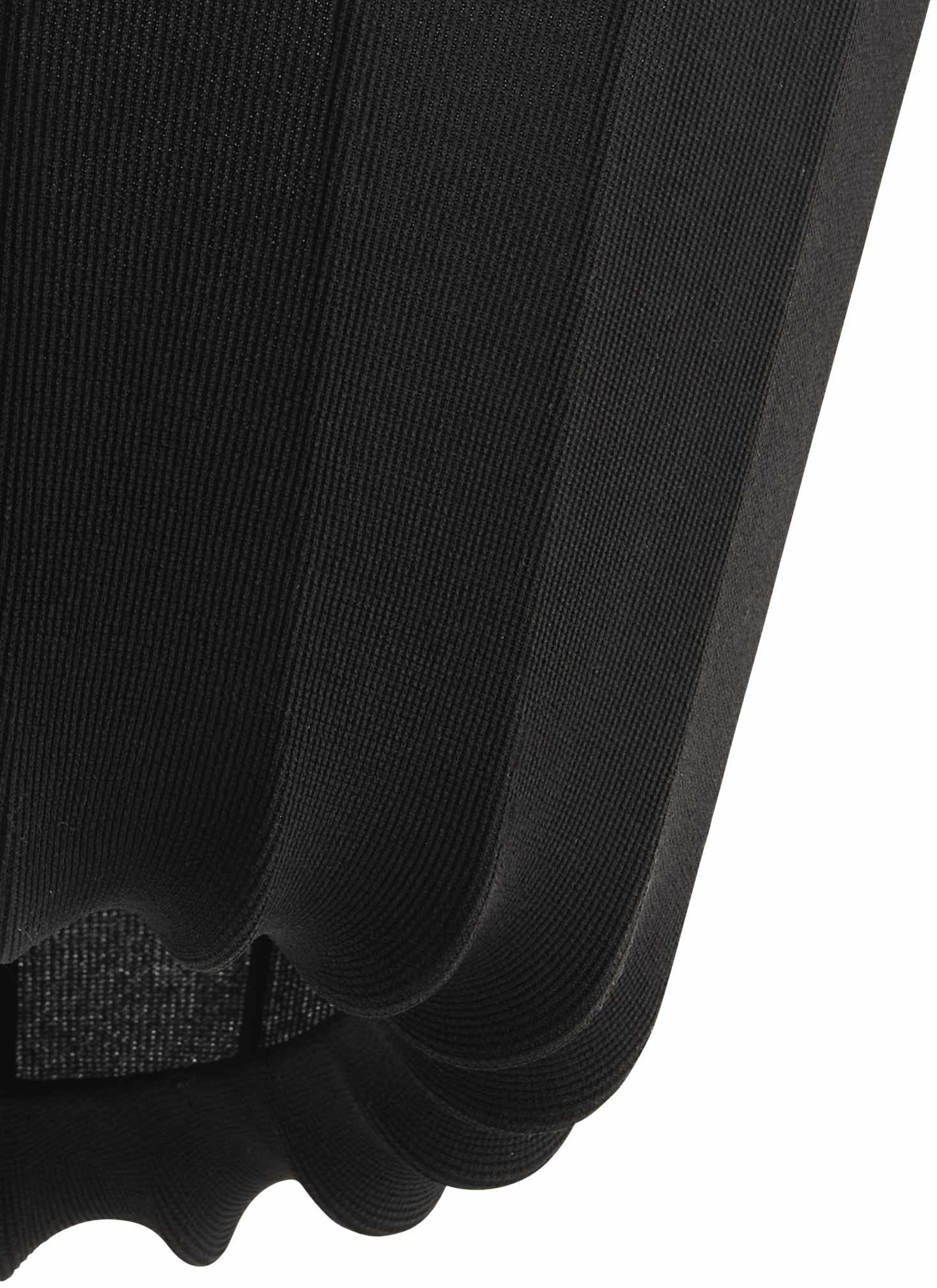 Close-up of a black dress with a textured fabric detail on a white background