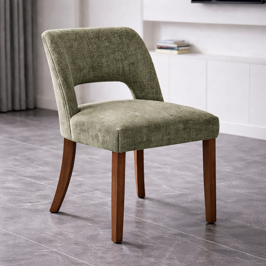 Green upholstered chair with wooden legs on a gray tiled floor.