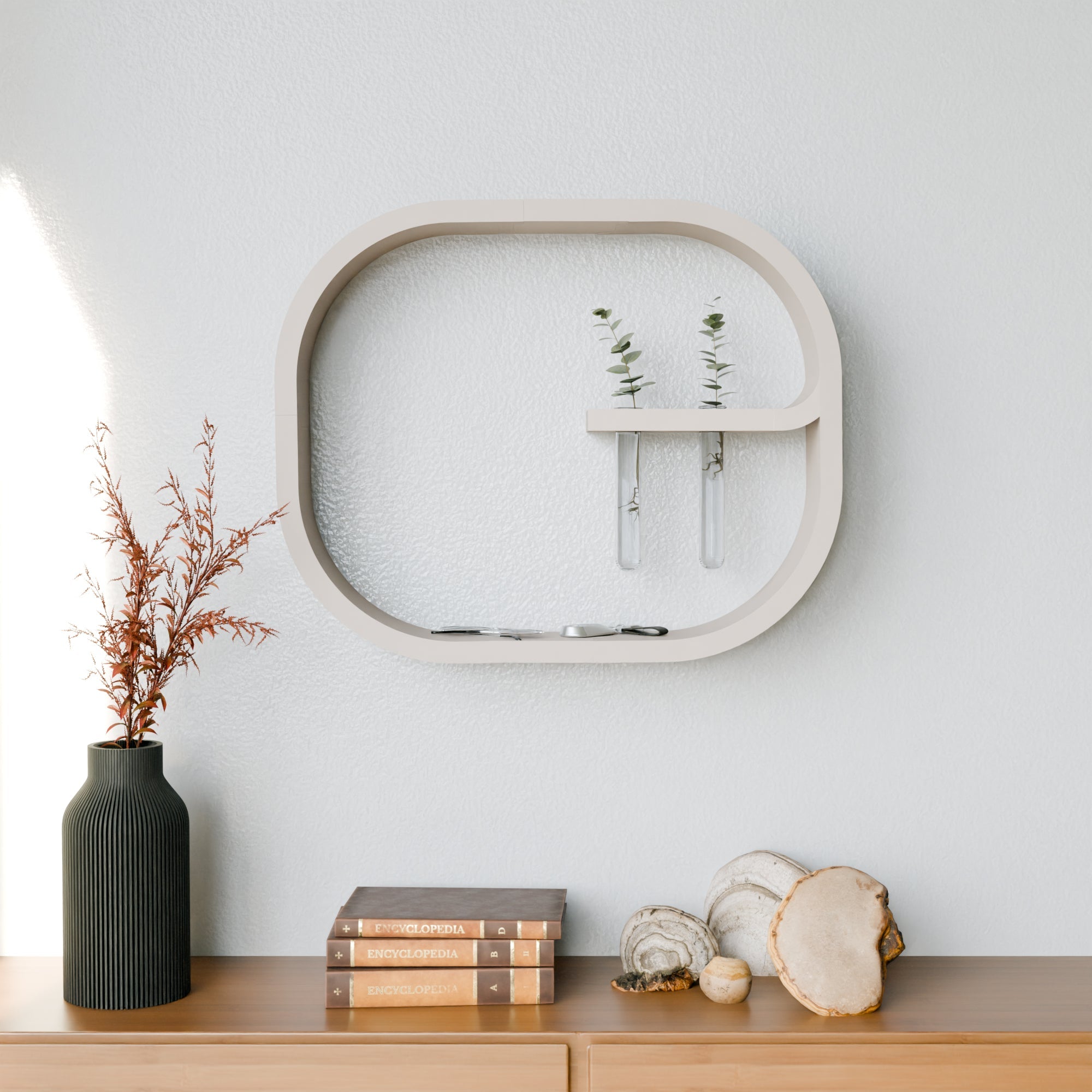 Decorative wall shelf with a plant, books, and decorative items on a wooden surface against a light gray wall.