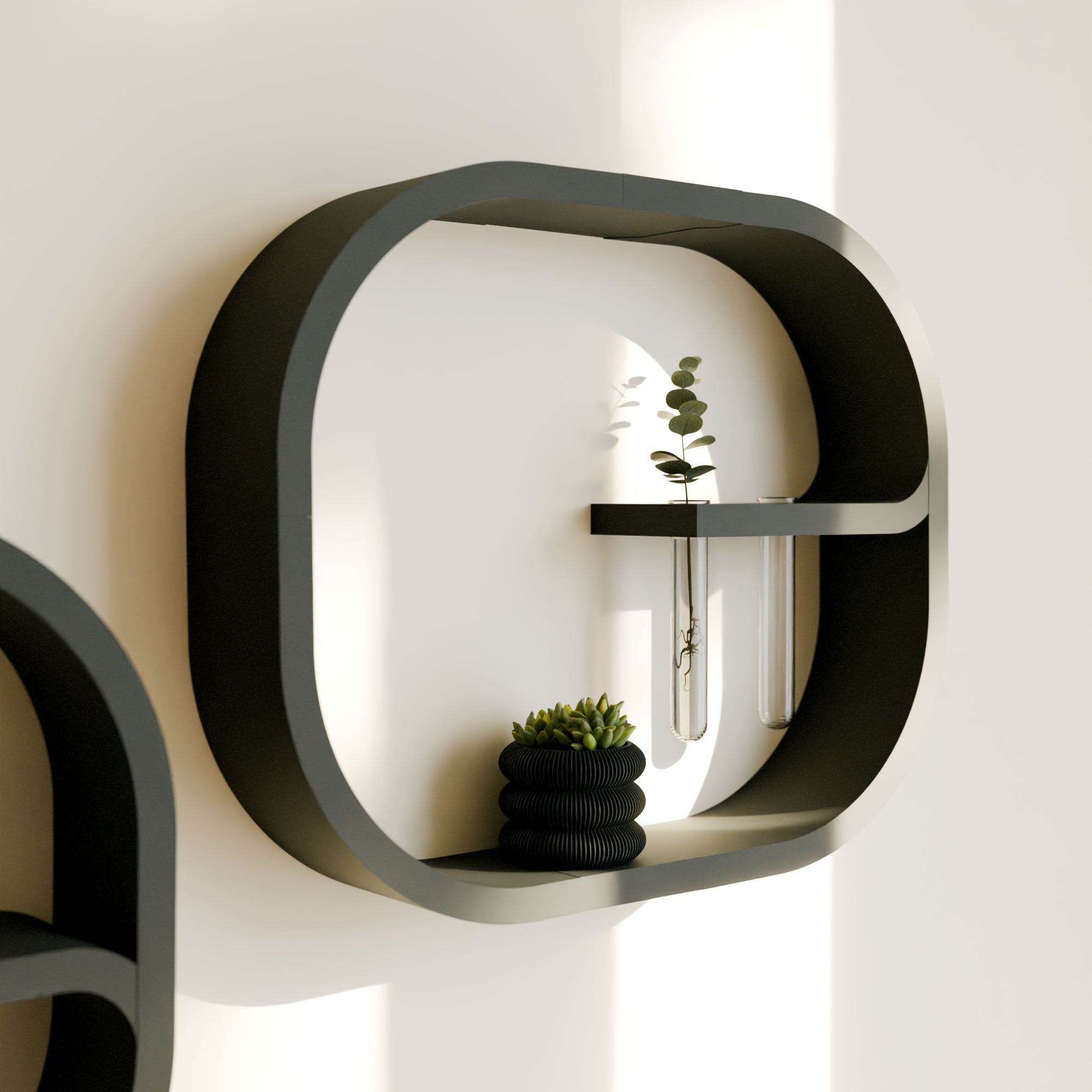 Modern black wall shelf with decorative items on a white wall