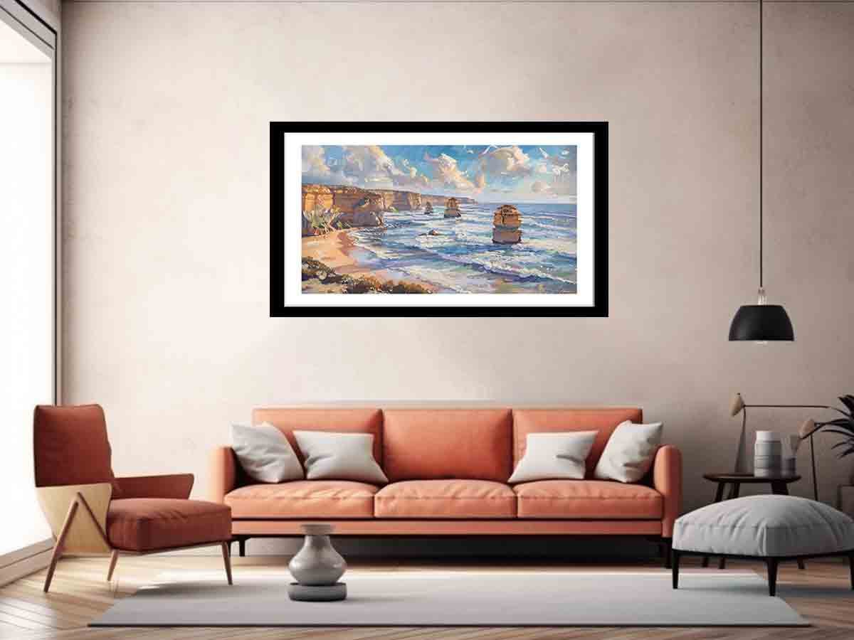 Framed artwork of a coastal scene above an orange sofa in a living room.