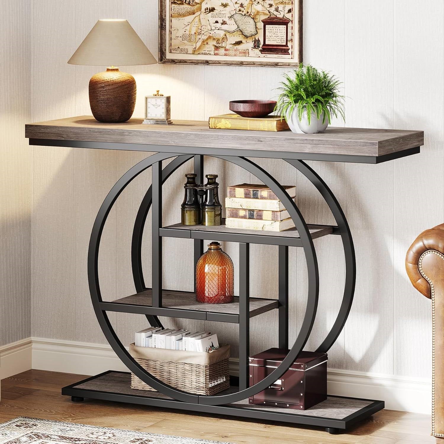 Decorative console table with circular metal frame and wooden top in a room setting.