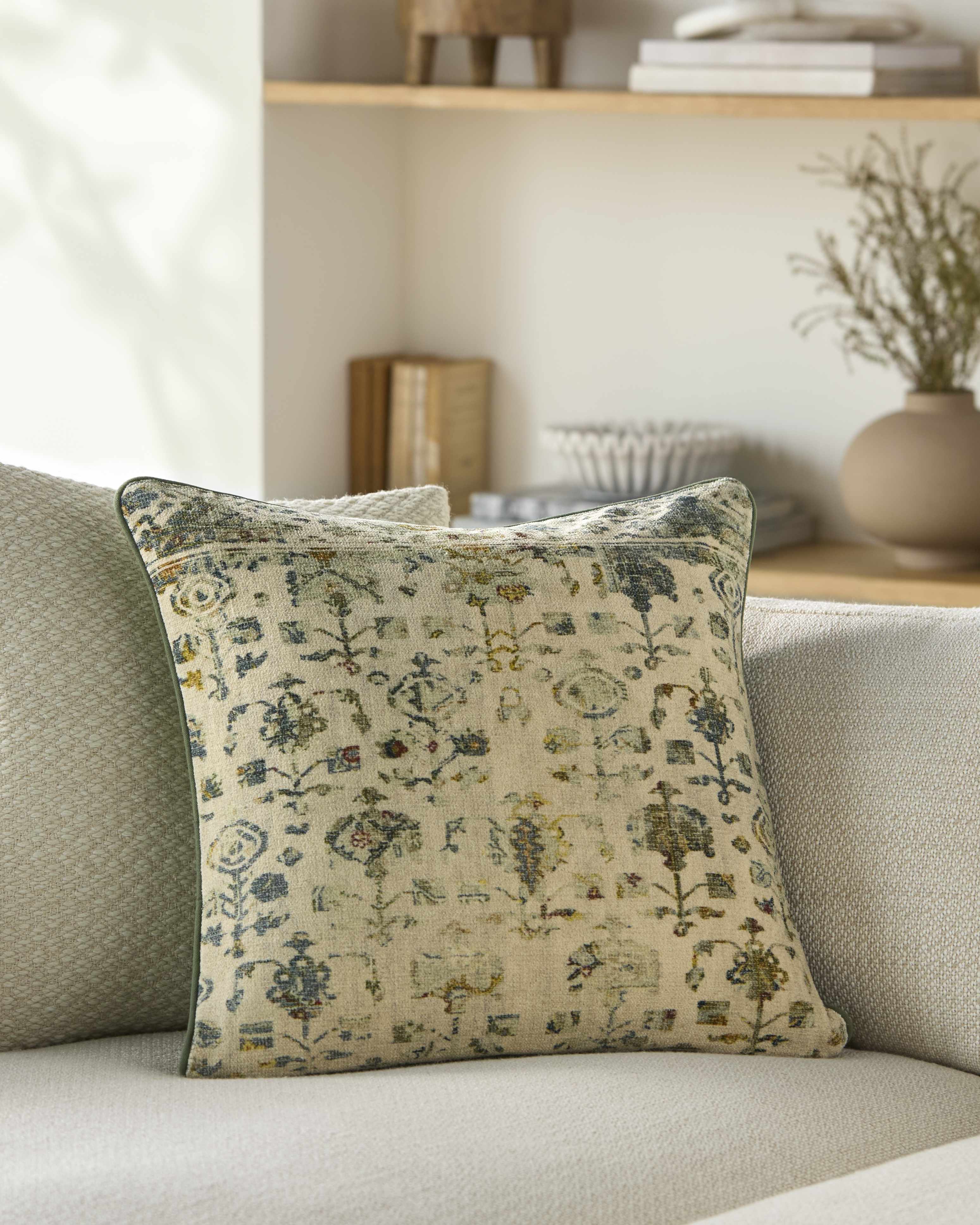 Decorative pillow with floral pattern on a sofa in a living room setting