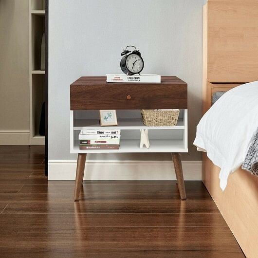Wooden nightstand with books and a clock in a bedroom setting