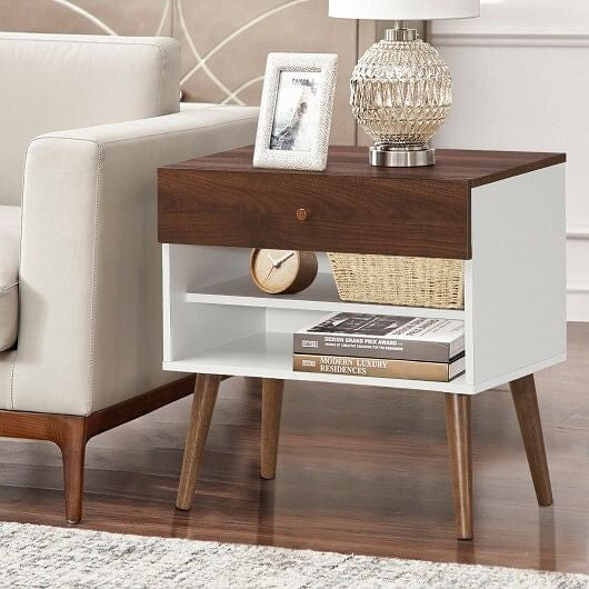 Wooden nightstand with books, a basket, and a clock in a bedroom setting.