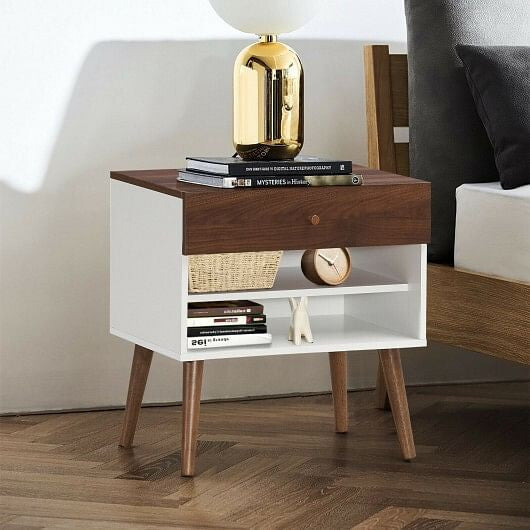 Wooden nightstand with books, a basket, and a clock in a bedroom setting.