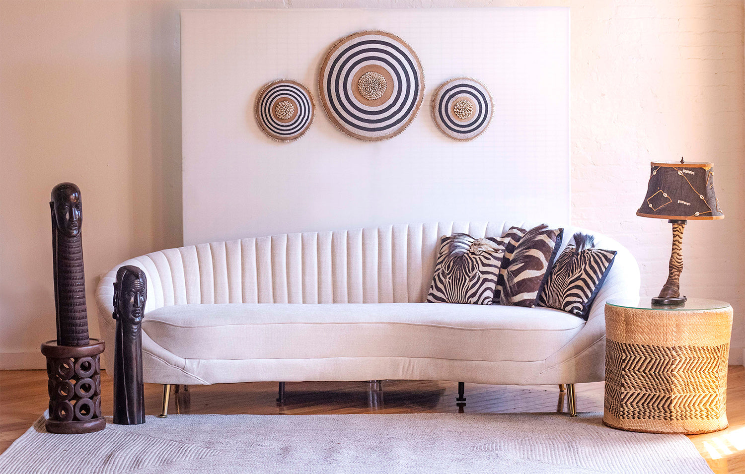 Living room with a white sofa, decorative pillows, and wall art.