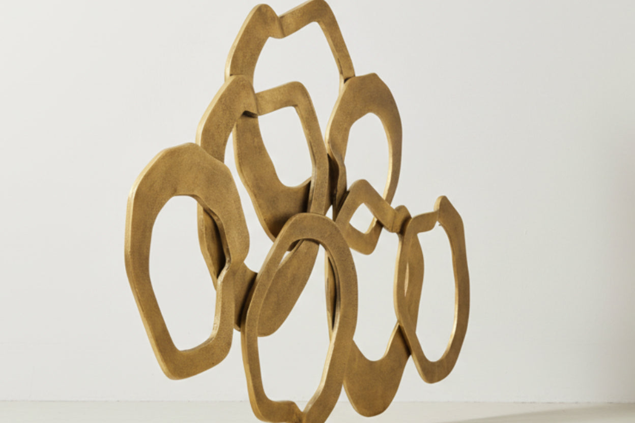 Decorative gold metal piece on a white background