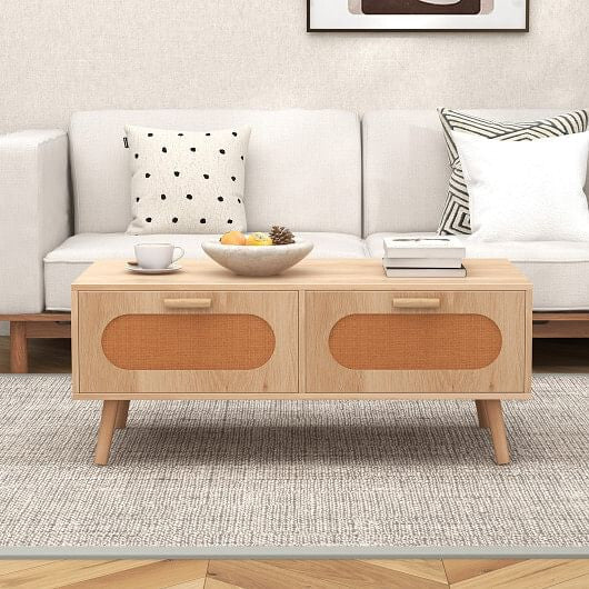Wooden coffee table in front of a white sofa with decorative items.
