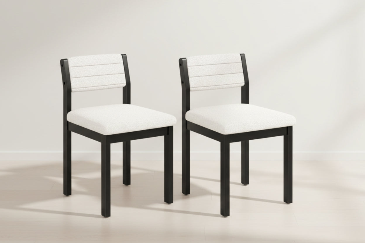 Two black chairs with white cushioned seats on a white background