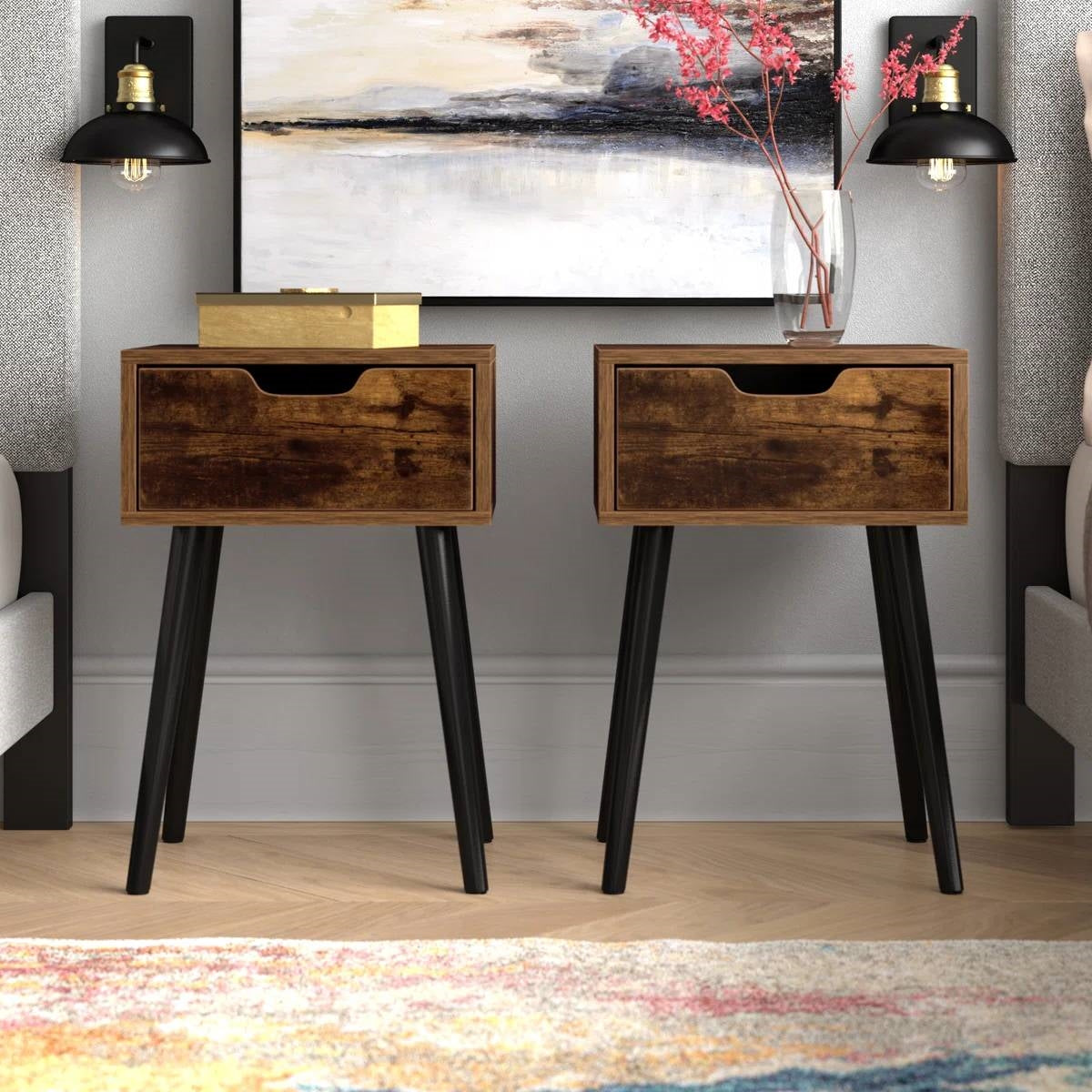Two wooden nightstands with black legs in a room setting.