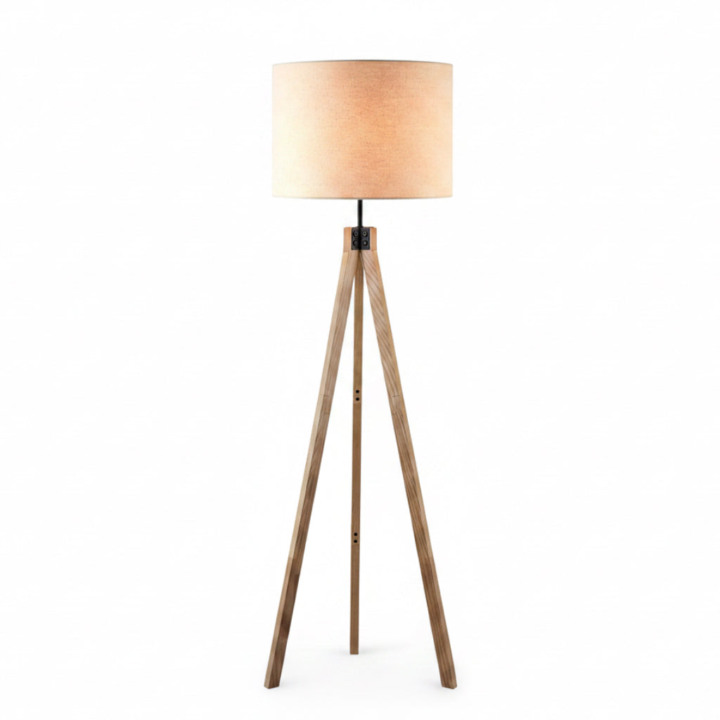 Wooden tripod floor lamp with a beige shade on a white background