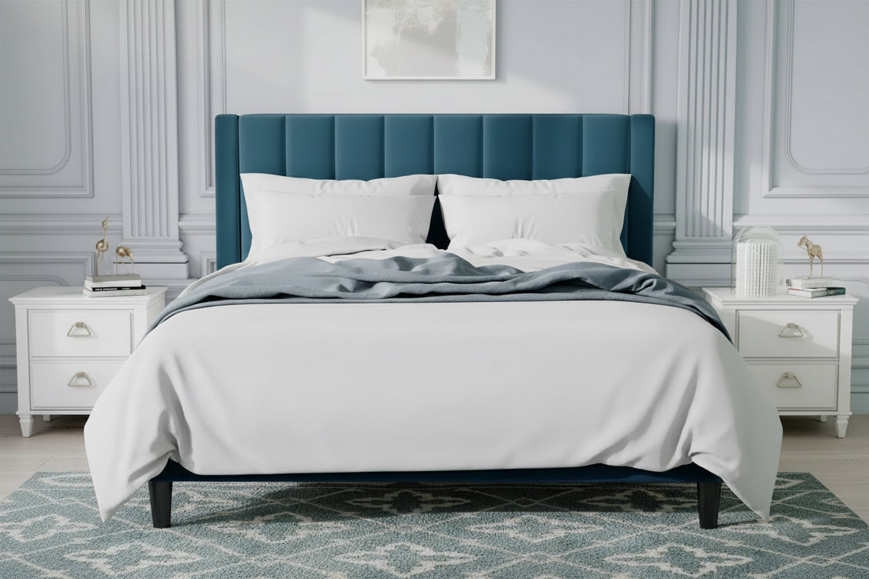 Blue upholstered bed with white bedding in a stylish bedroom.