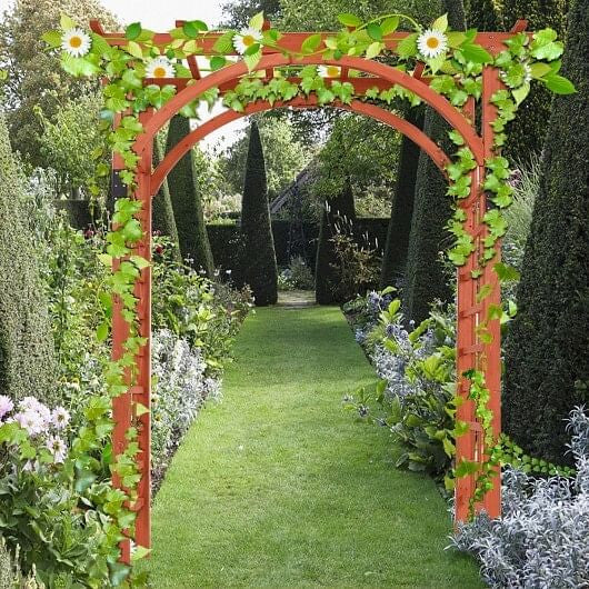Garden archway with climbing plants and flowers in a lush garden setting