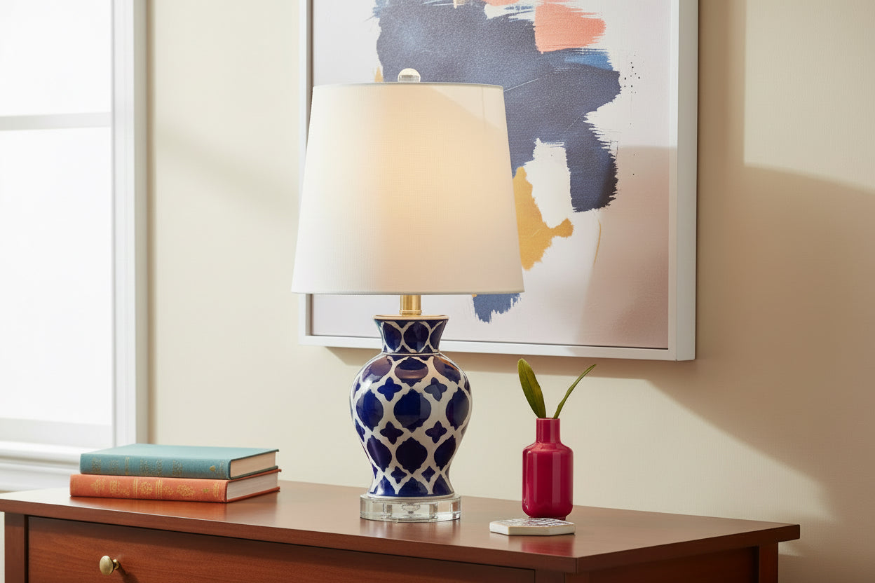 Table lamp with blue and white patterned base and beige lampshade on a white background