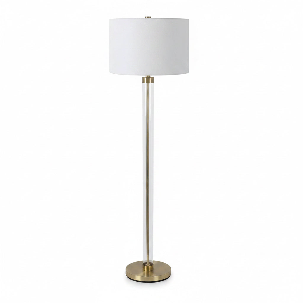 Floor lamp with a white shade and brass base on a white background