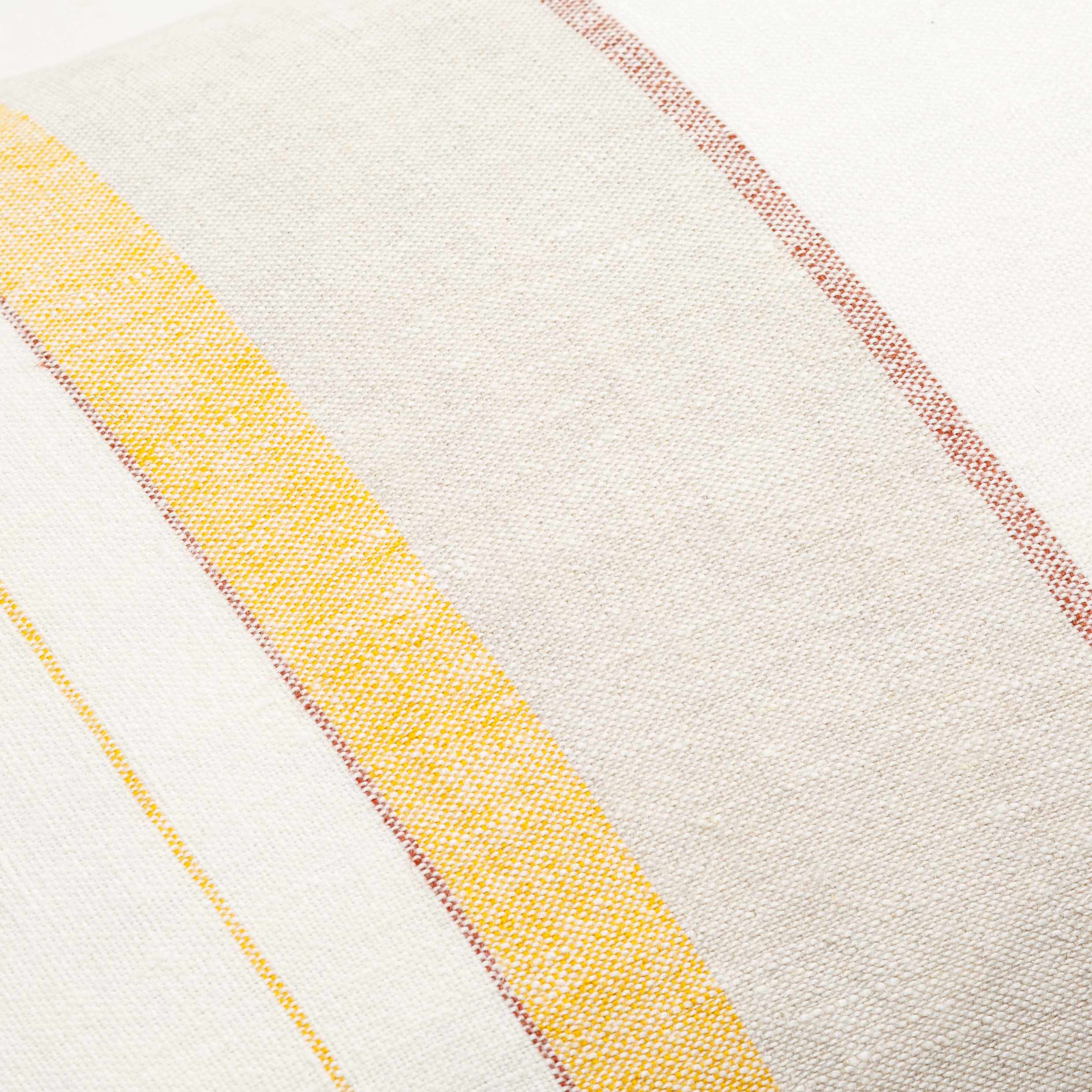Close-up of a fabric with yellow and red stripes on a white background