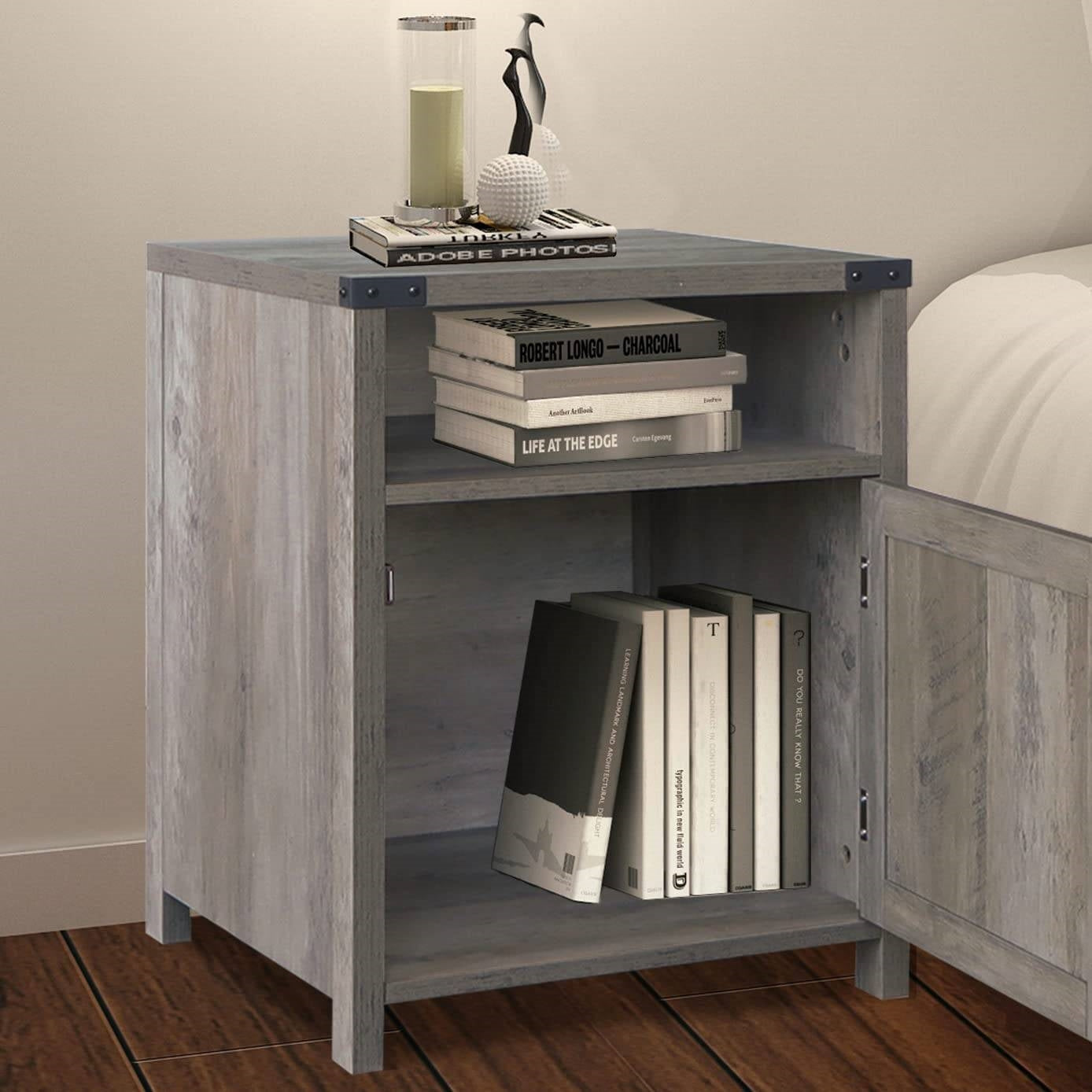 Gray wooden nightstand with books and decor items on a wooden floor.