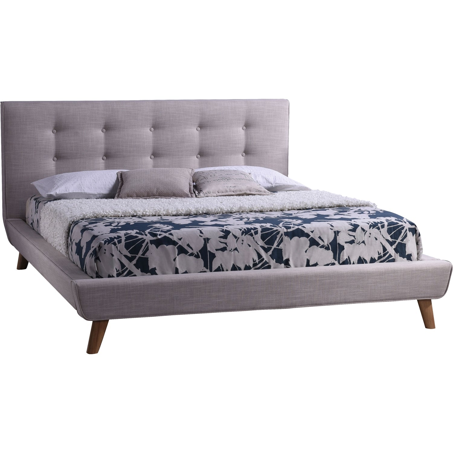 Gray upholstered bed with floral bedding on a white background
