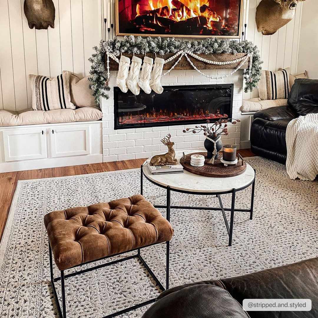 Cozy living room with a fireplace, stockings, and decorative items.