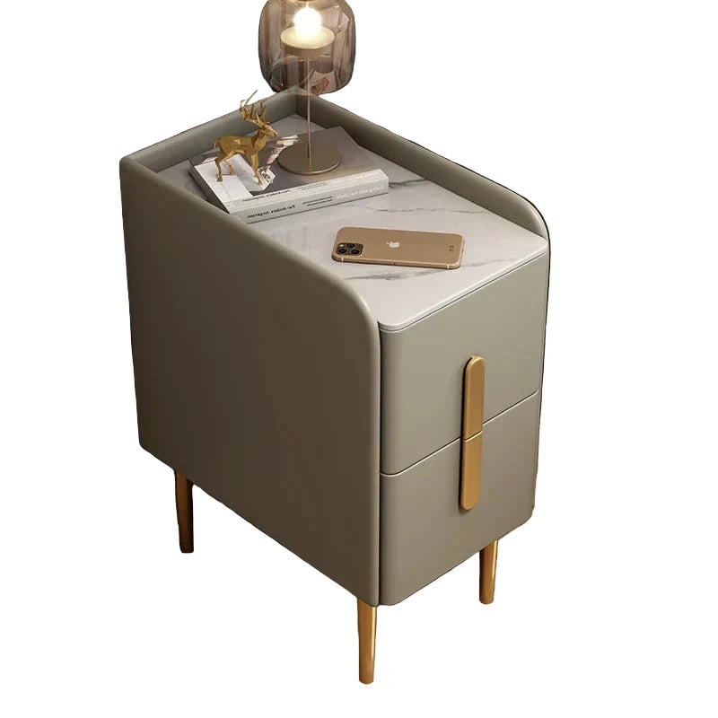 Modern nightstand with marble top and gold accents in a bedroom setting