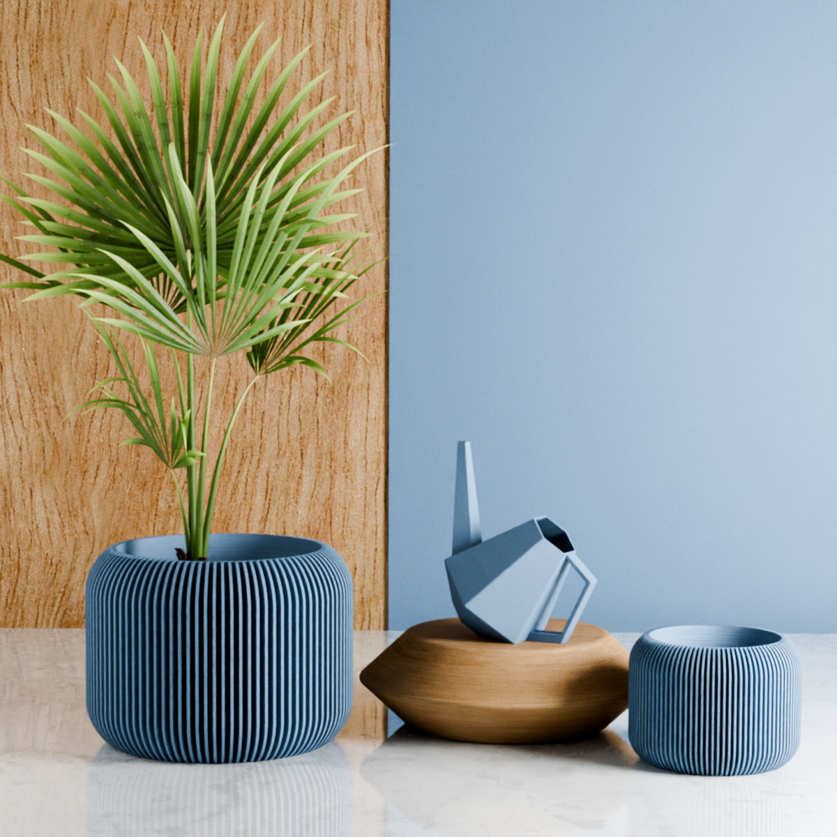 Decorative items including a potted plant, wooden bowl, and blue textured containers on a light surface with a wooden panel and blue wall in the background.