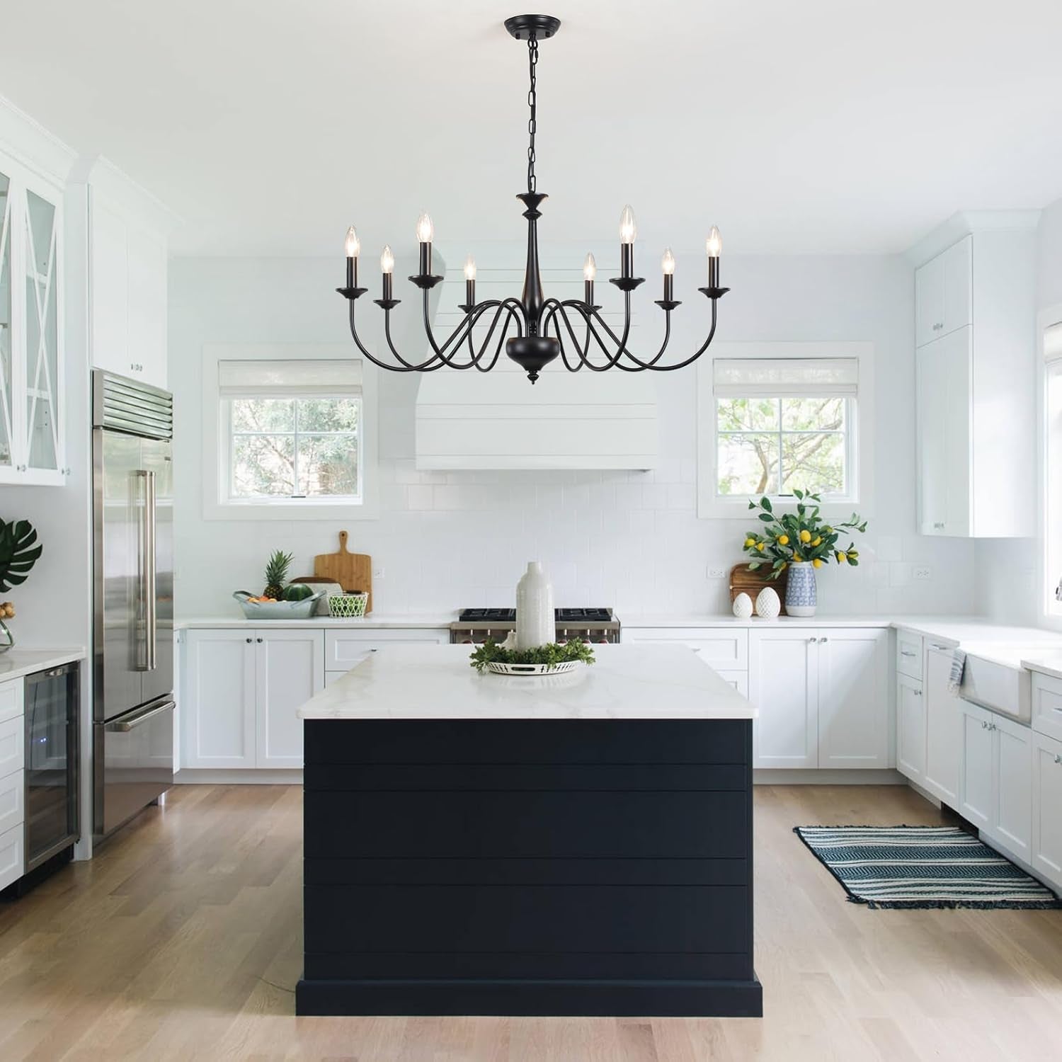 Modern kitchen with black island and chandelier
