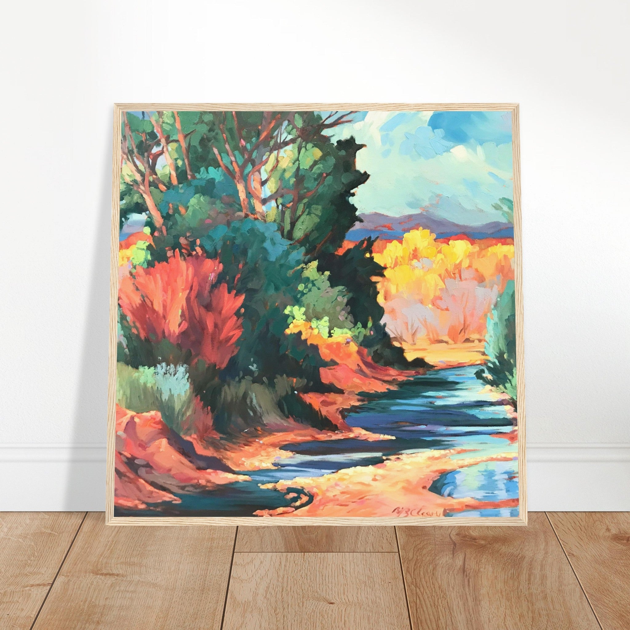 Colorful landscape painting of a forest and river on a white wall.