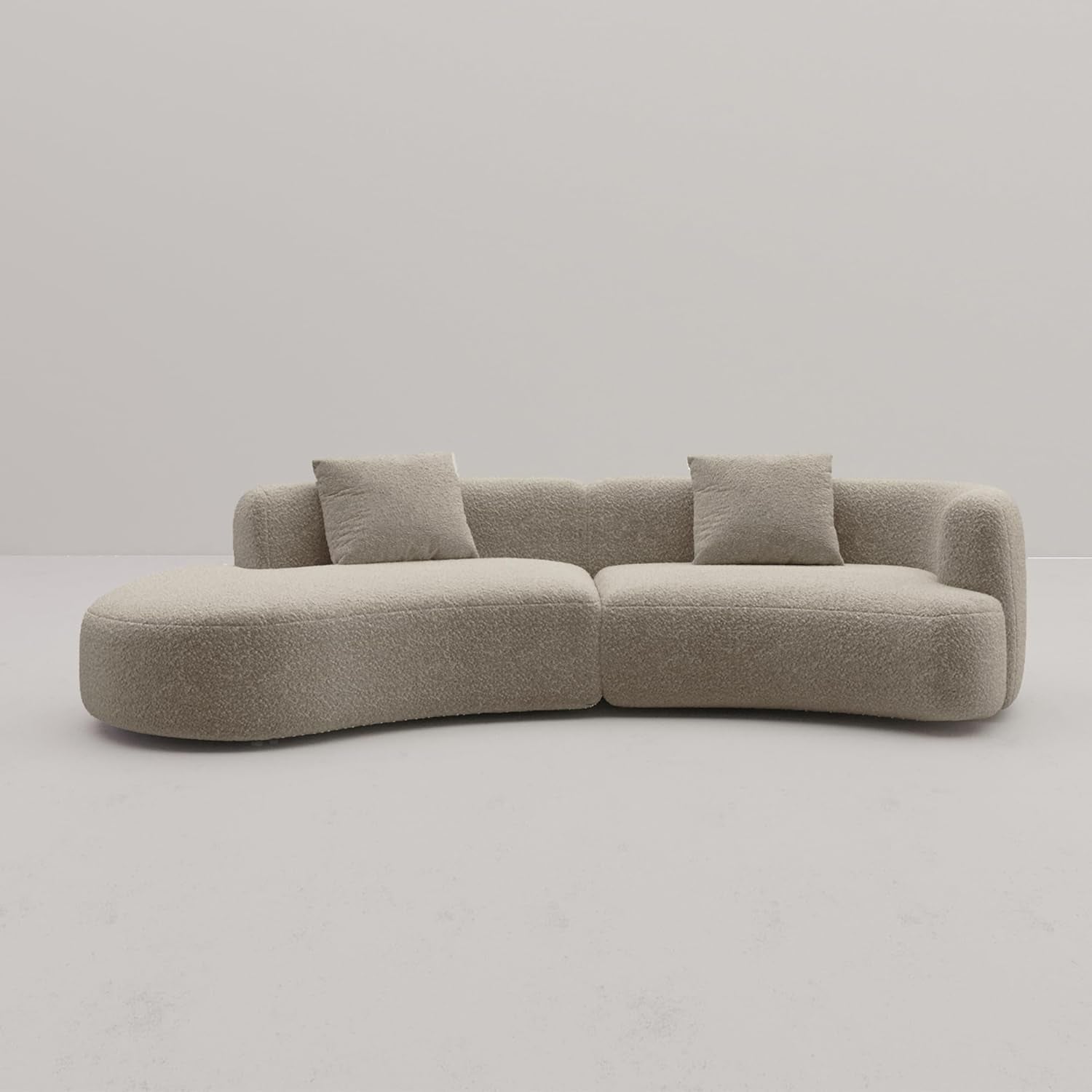 Beige sofa with three cushions on a plain background