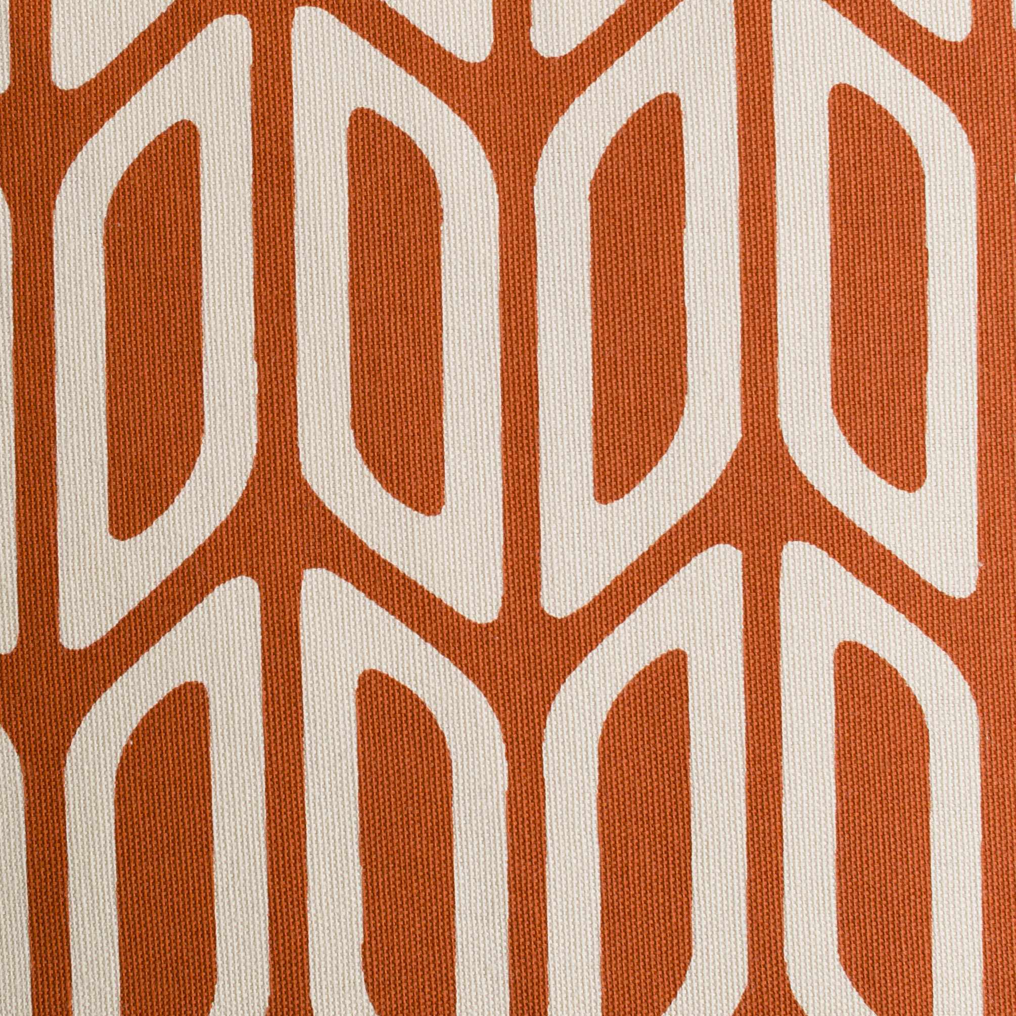 Close-up of a fabric with a geometric pattern on an orange background