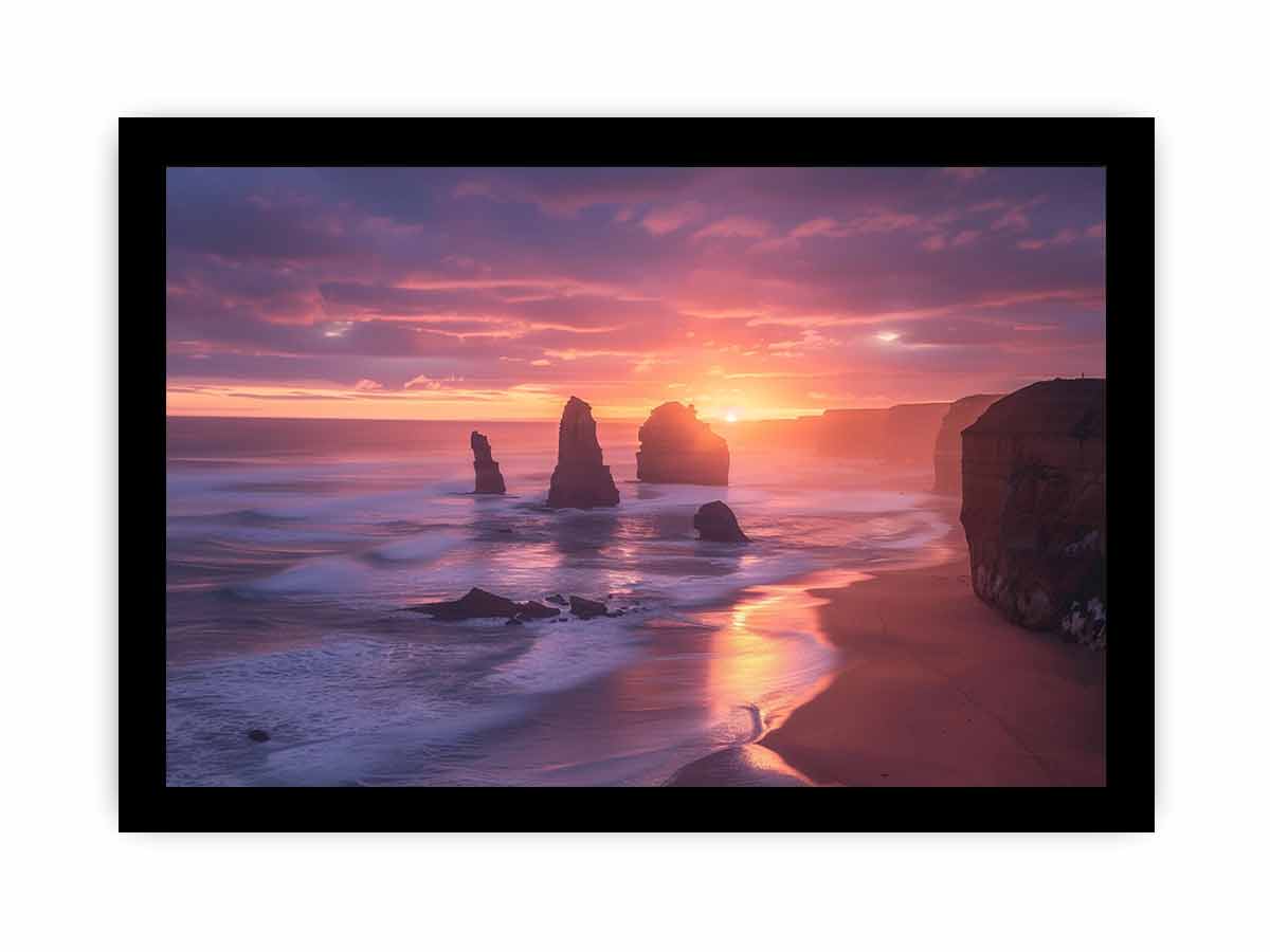 Sunset over a beach with rock formations, framed by a black border.