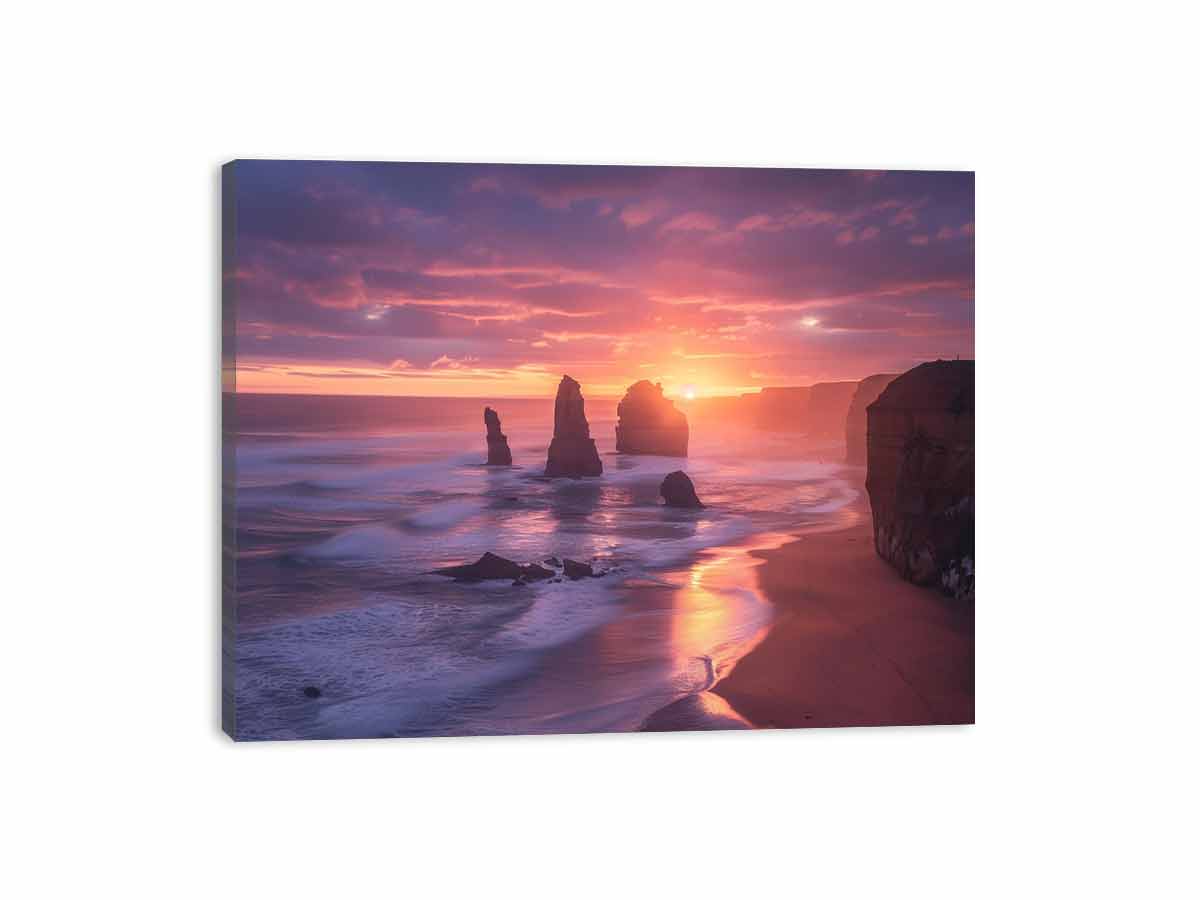 Beach scene with rocks and a colorful sunset sky