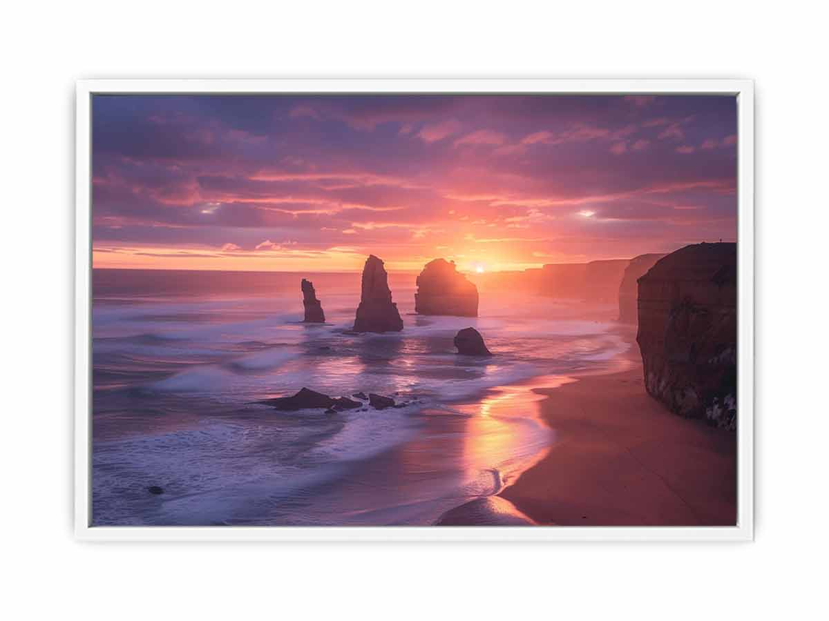 Sunset over ocean with rock formations on a beach