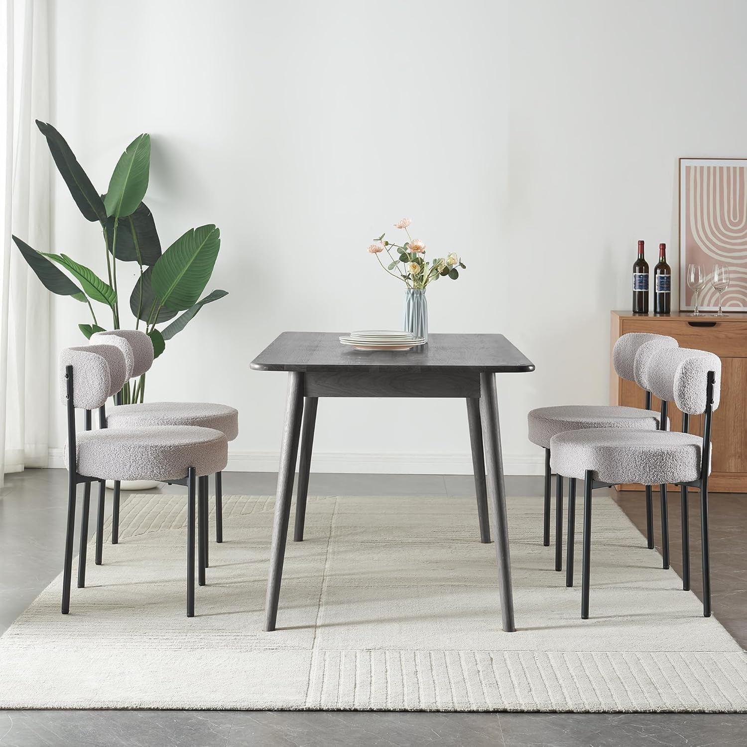 Dining room with a dark wooden table and gray chairs on a light rug.