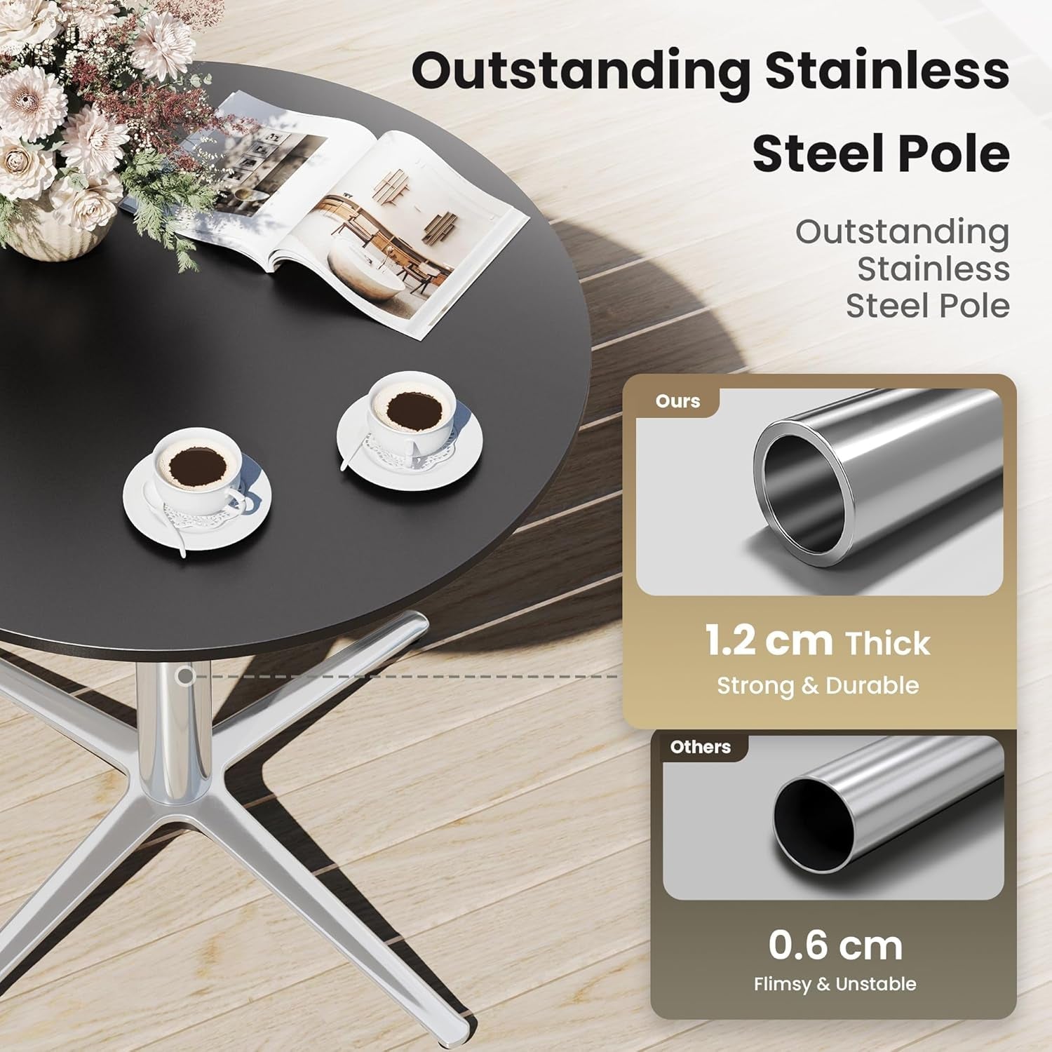 Black round table with a stainless steel pole, coffee cups, and an open book on a wooden floor.