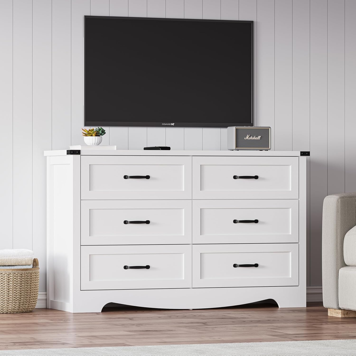 White dresser with six drawers in a room with a TV above it.