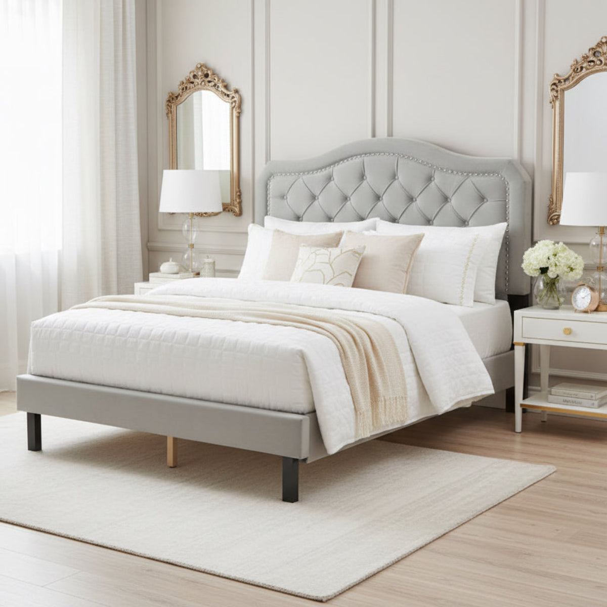 Gray upholstered bed with tufted headboard in a room setting.