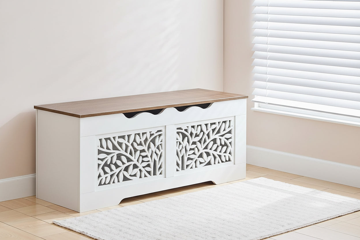 Person sitting on a white storage bench with wooden top in a room.