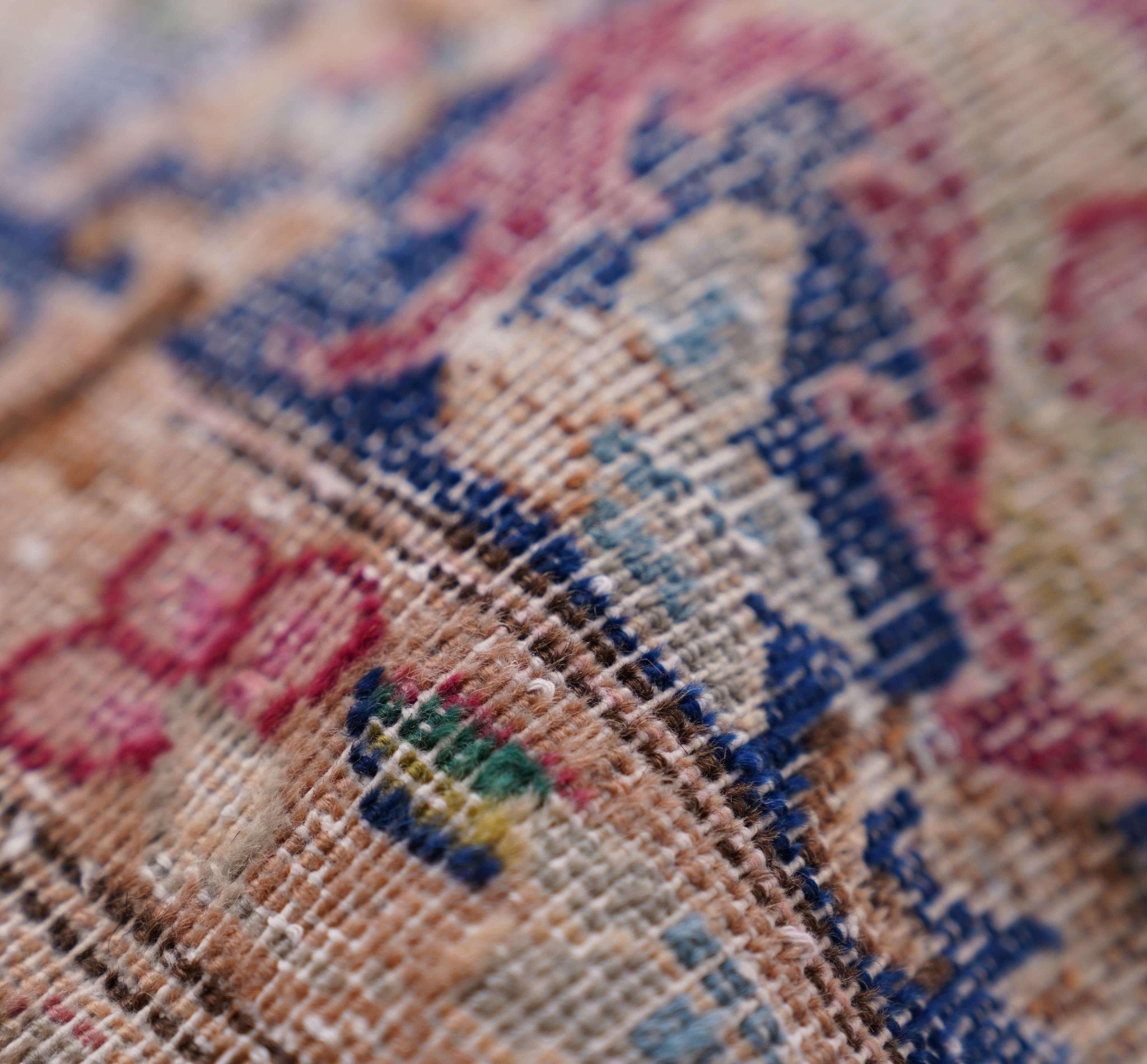 Close-up of a needlepoint fabric with floral patterns