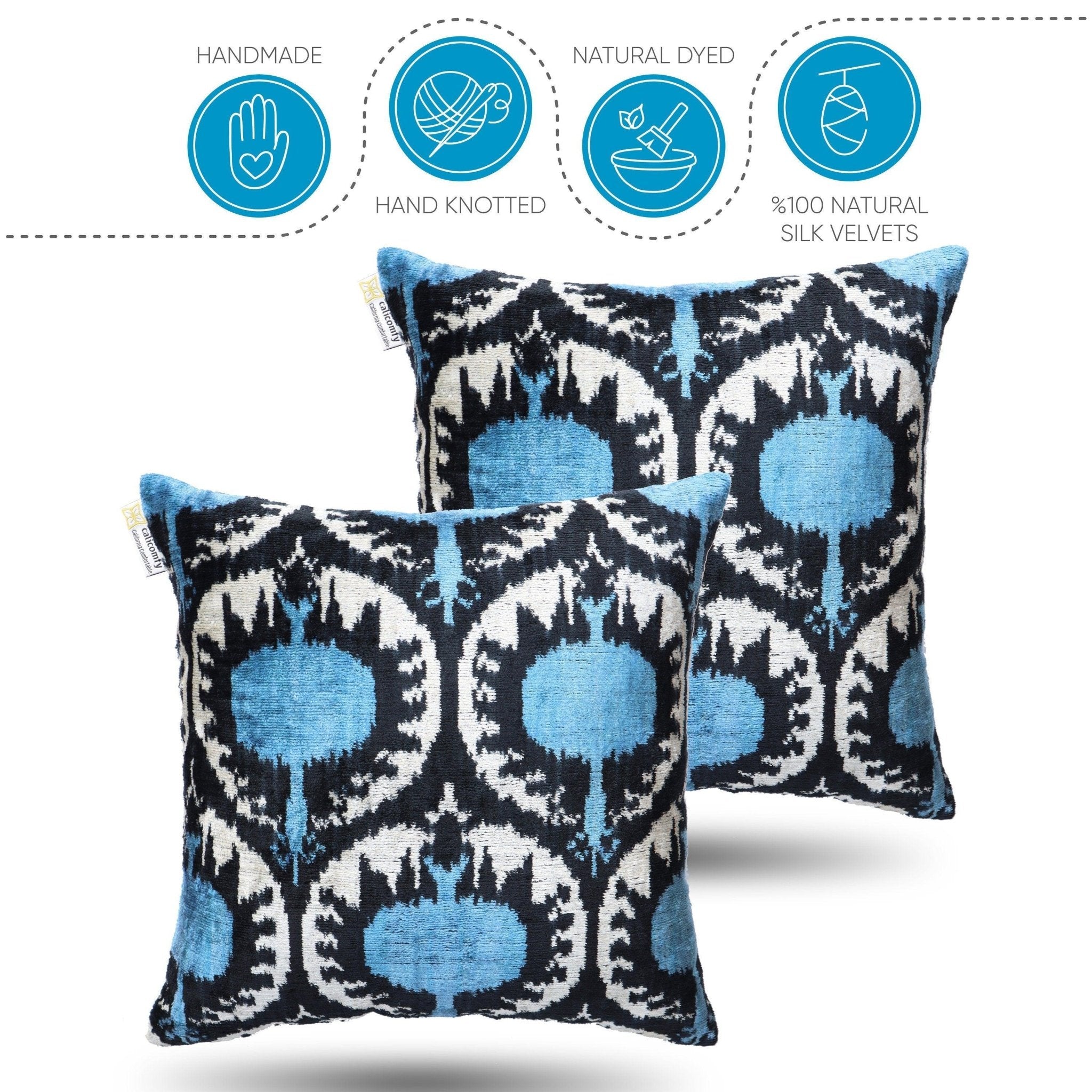 Two blue and black patterned pillows with certification icons on a white background