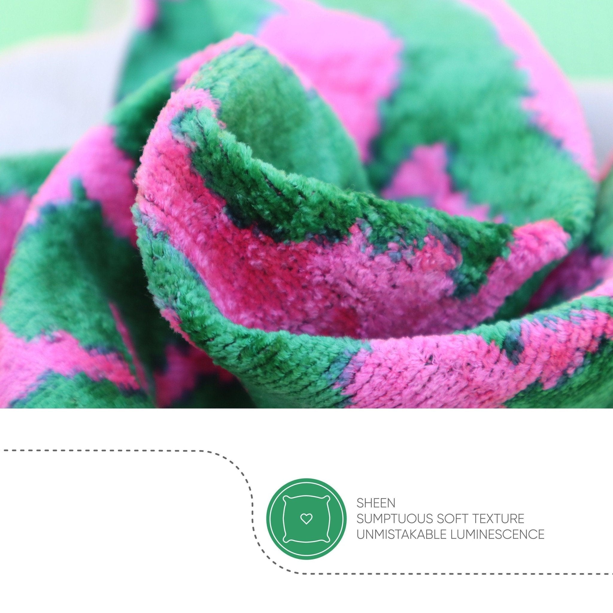 Close-up of a green and pink fabric with a sheen and soft texture label.