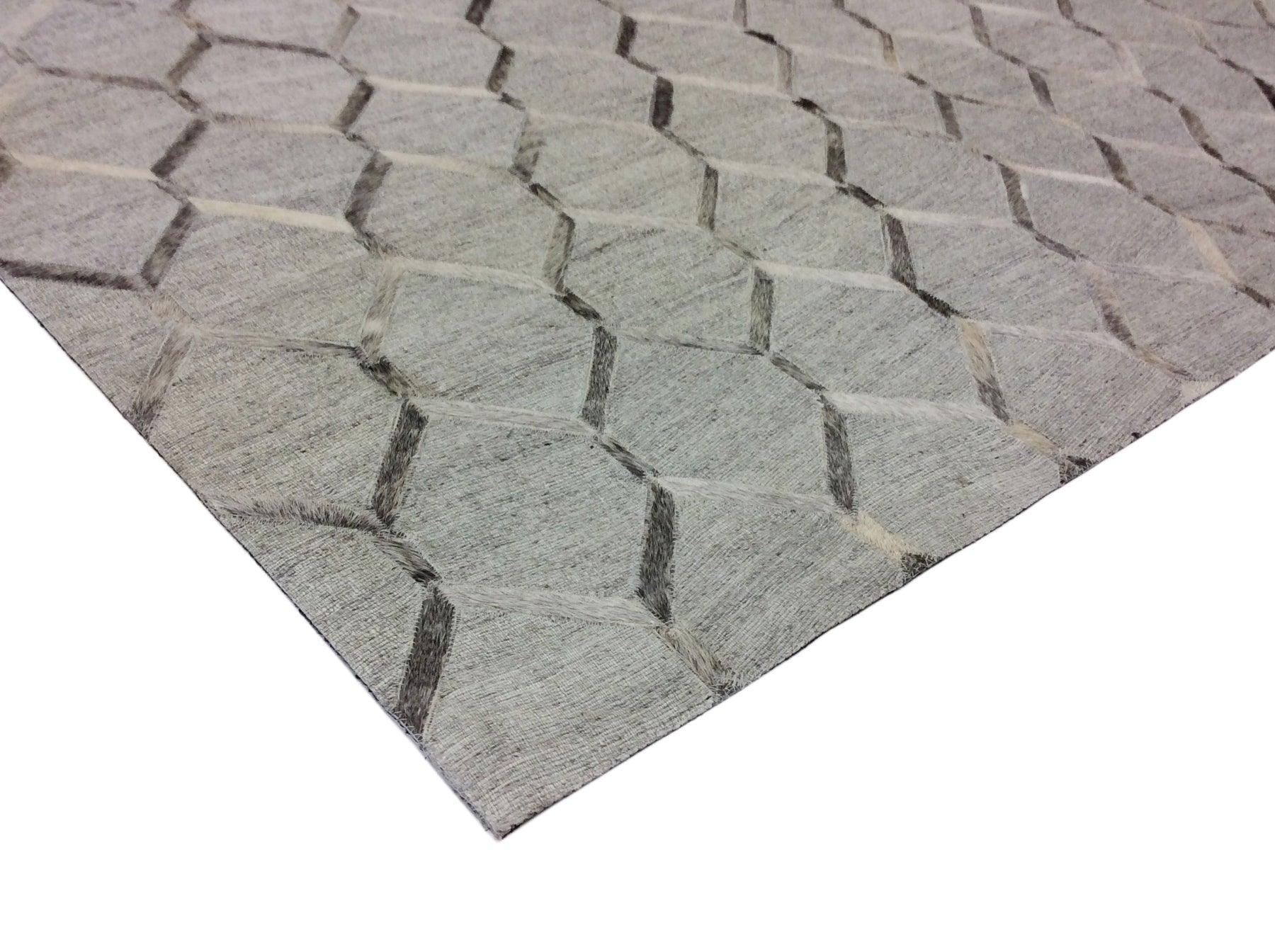 Gray textured rug with geometric pattern on a white background