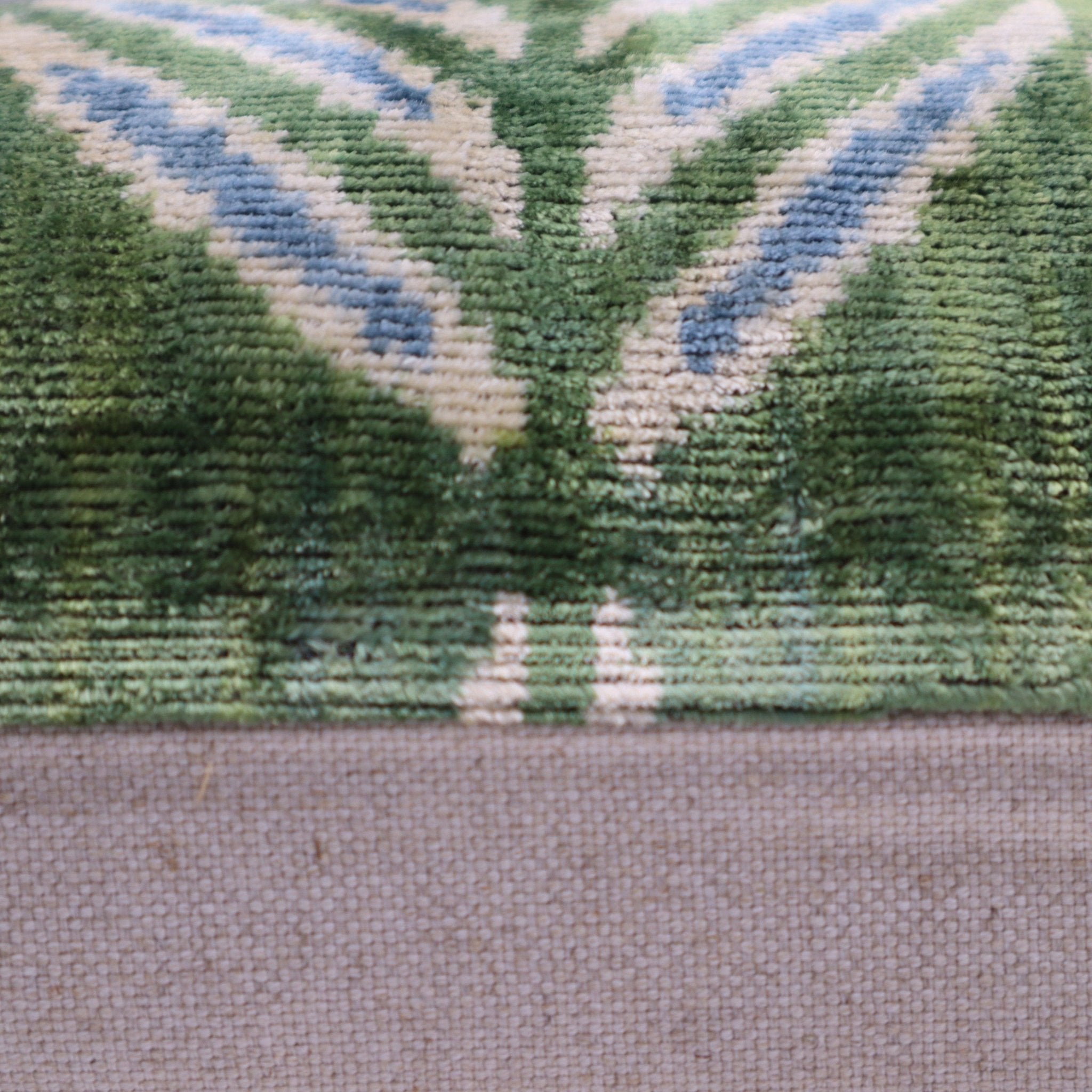 Close-up of a textured fabric with green and blue pattern