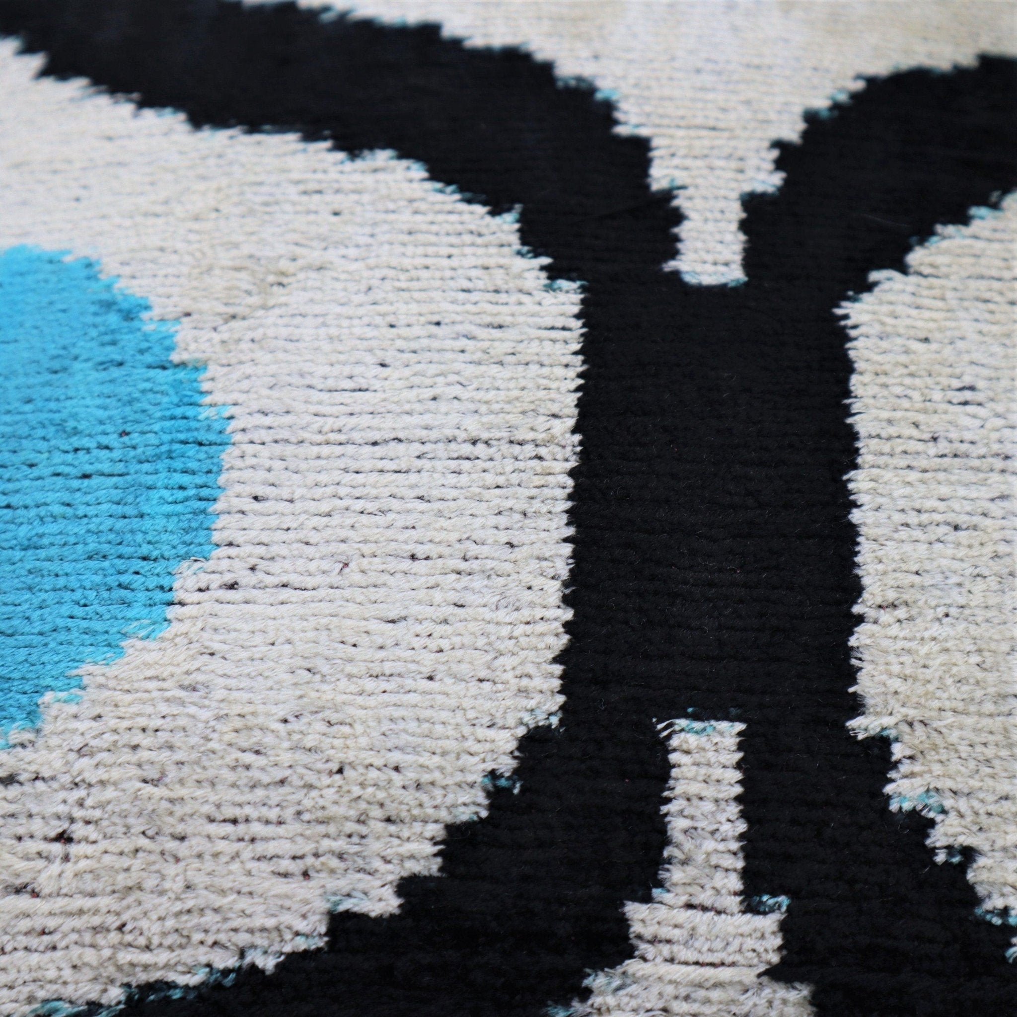 Close-up of a textured surface with black, white, and blue patterns