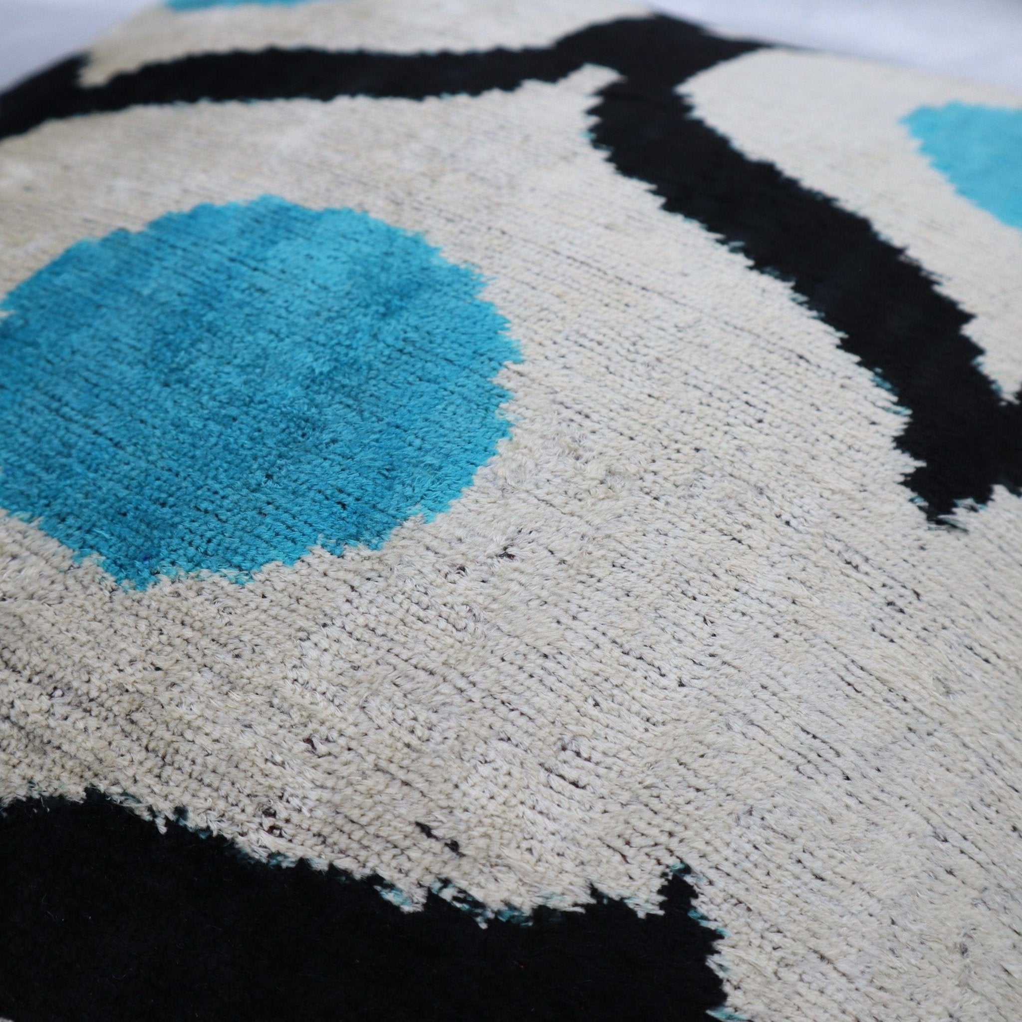 Close-up of a textured surface with blue, black, and beige colors.