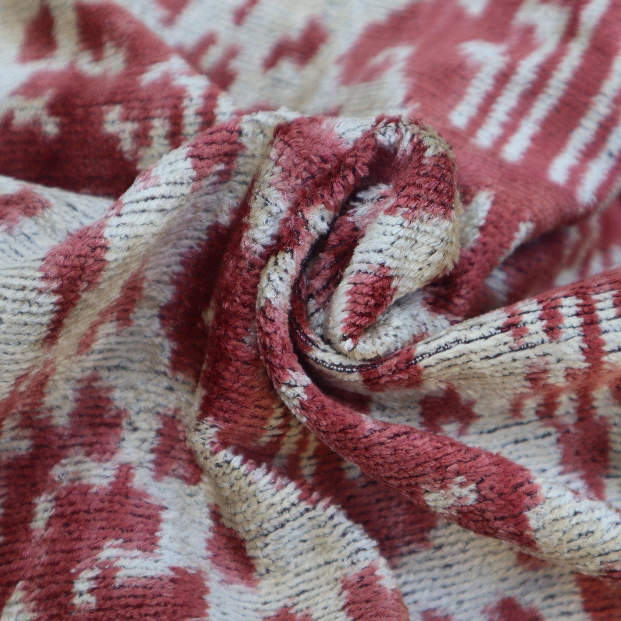Close-up of textured red and beige fabric with a pattern